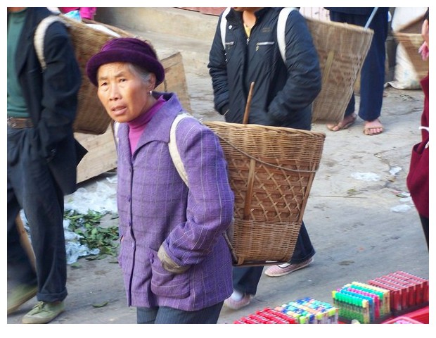 Women with baskets, Yunnan, China