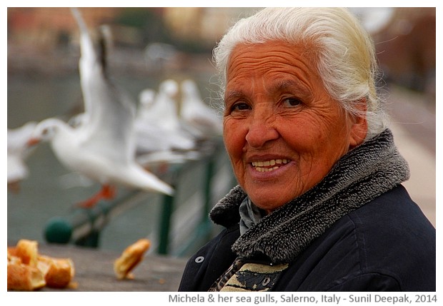 Michela giving bread to seagulls, Salerno, Italy - images by Sunil Deepak, 2014