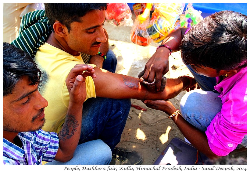 Boy getting a tatoo, Dushhera fair, Kullu, Himachal Pradesh, India - Images by Sunil Deepak