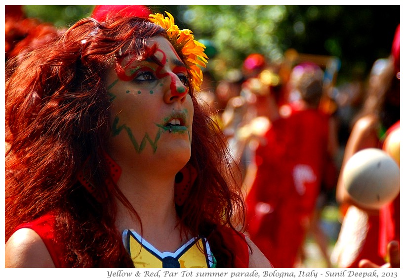 Persons in red & yellow costumes, Par tot summer parade, Bologna, Italy - Images by Sunil Deepak