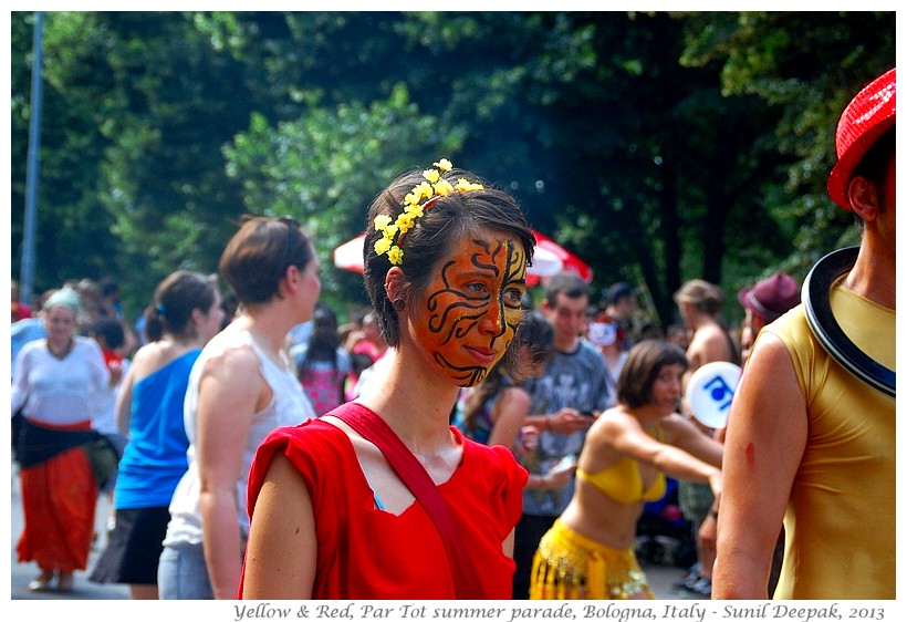 Persons in red & yellow costumes, Par tot summer parade, Bologna, Italy - Images by Sunil Deepak