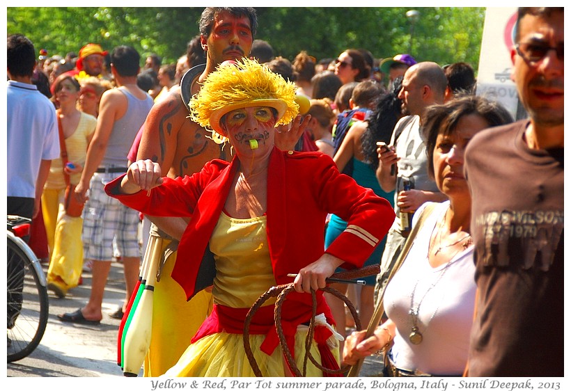 Persons in red & yellow costumes, Par tot summer parade, Bologna, Italy - Images by Sunil Deepak